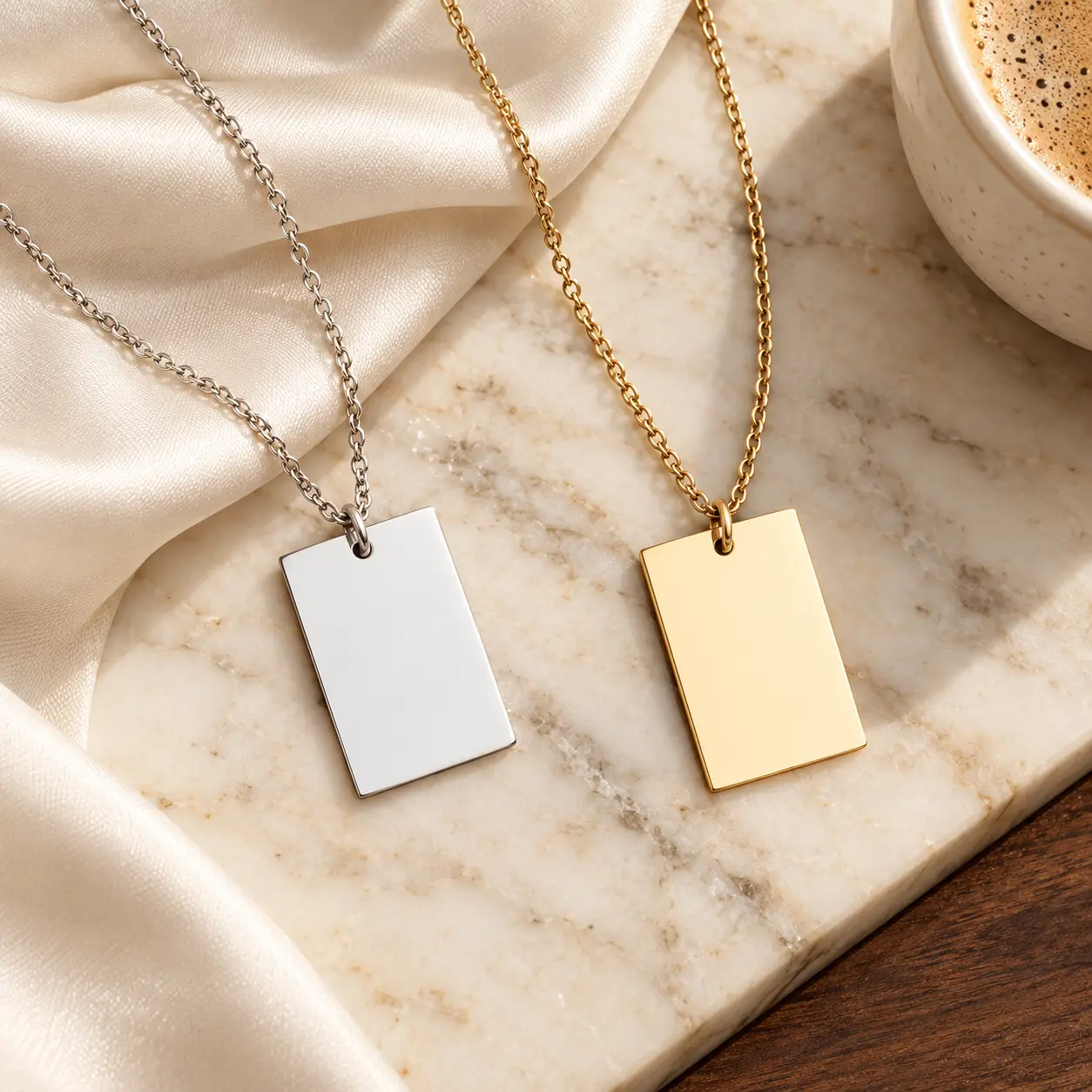 Blank gold and silver Classic Rectangle Pendant Necklaces displayed on ivory satin and marble