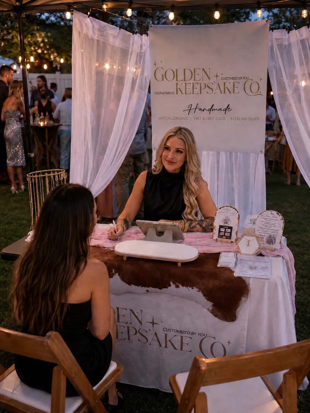 Golden Keepsake Co. evening booth with Cassandra creating jewelry for a guest
