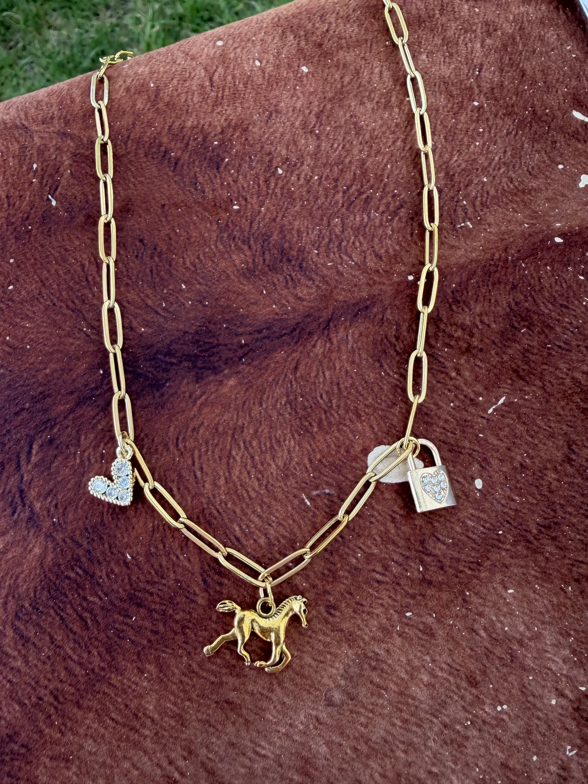 Gold charm necklace featuring a horse and sparkling keepsake charms