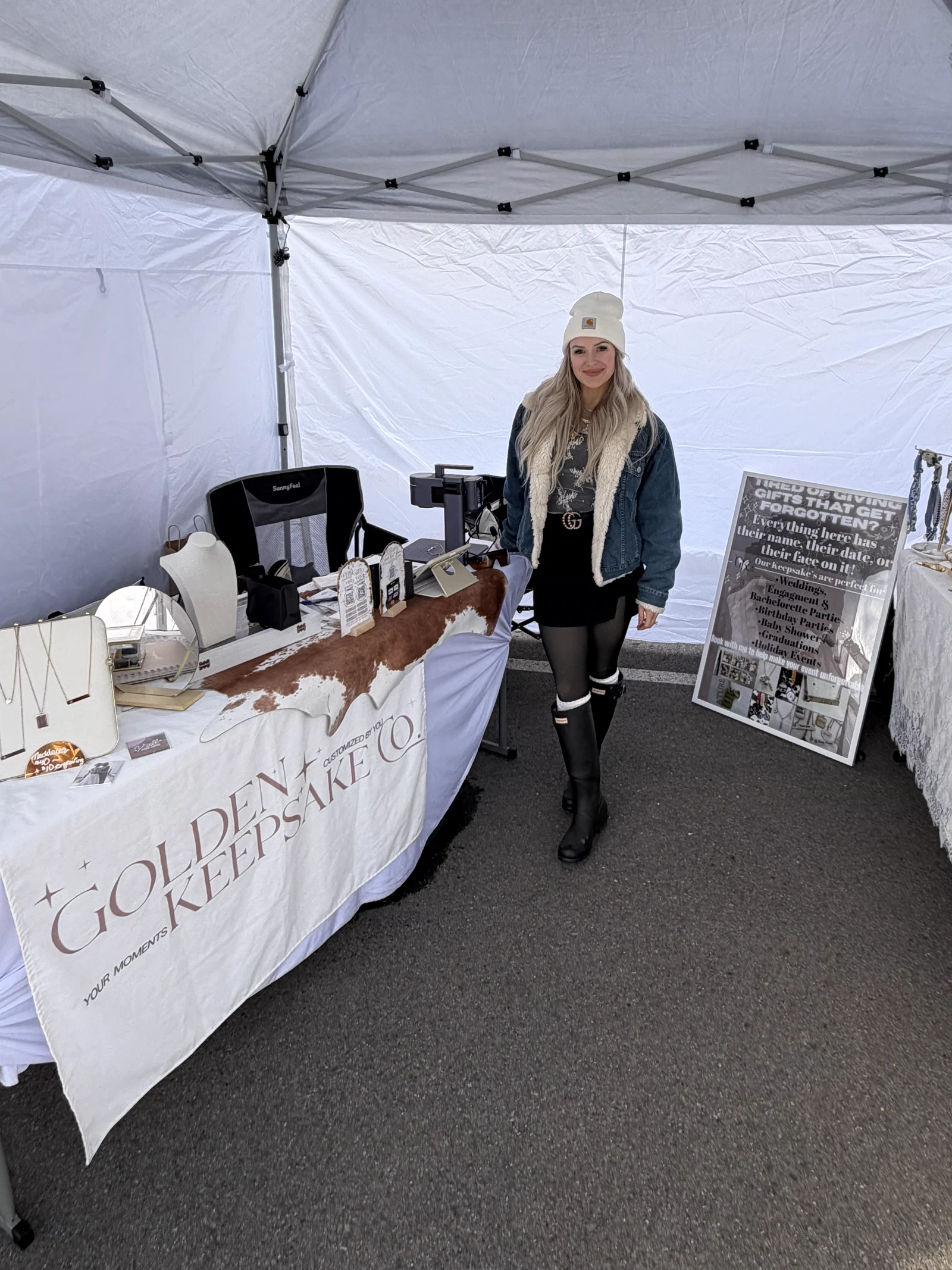 Cassandra wearing a white beanie inside her white Golden Keepsake Co. market tent